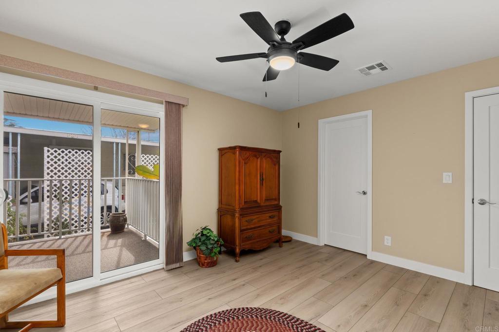 7467 Mission Gorge Road, Unit 104 Santee, CA 92071 - Photo 15 of 25 wooden floor in an empty room with a window