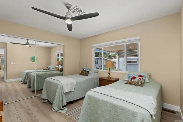 a bedroom with two beds and a chandelier