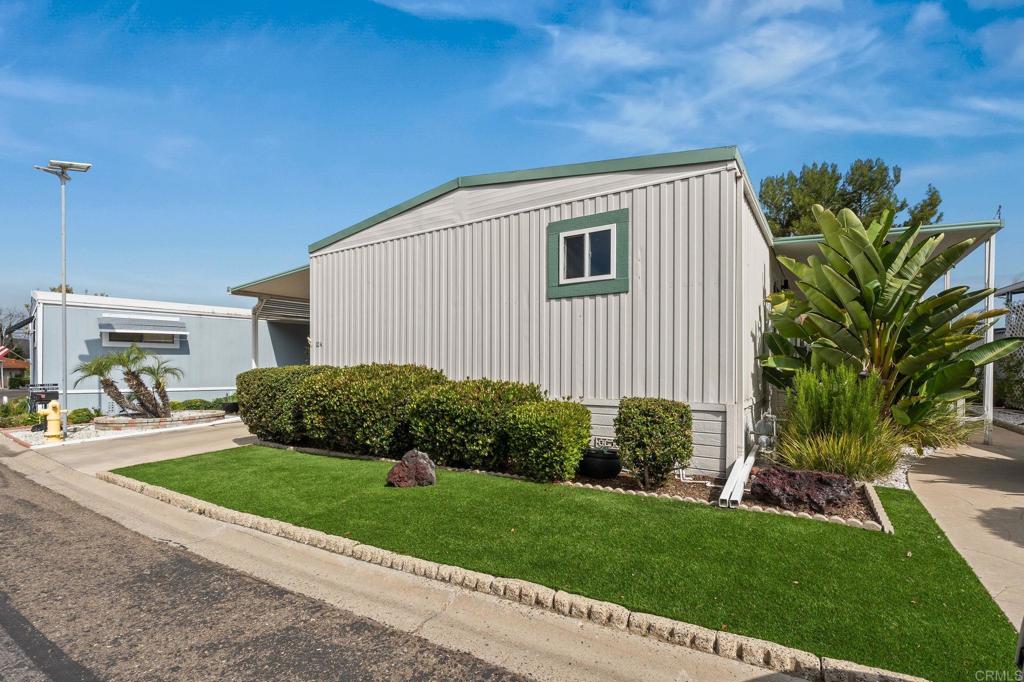 7467 Mission Gorge Road, Unit 104 Santee, CA 92071 - Photo 3 of 25 a view of a house with a yard