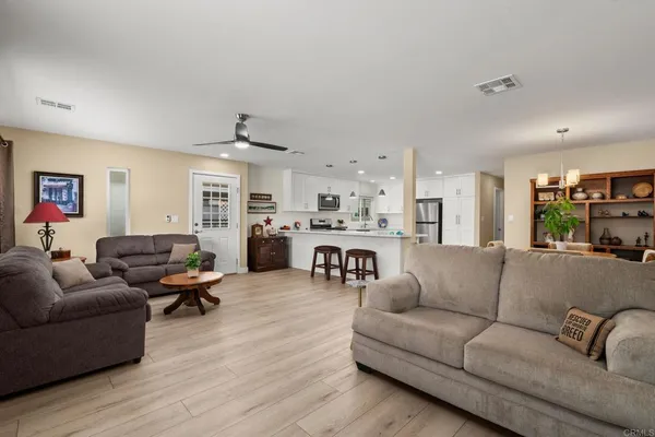 a living room with furniture and kitchen view