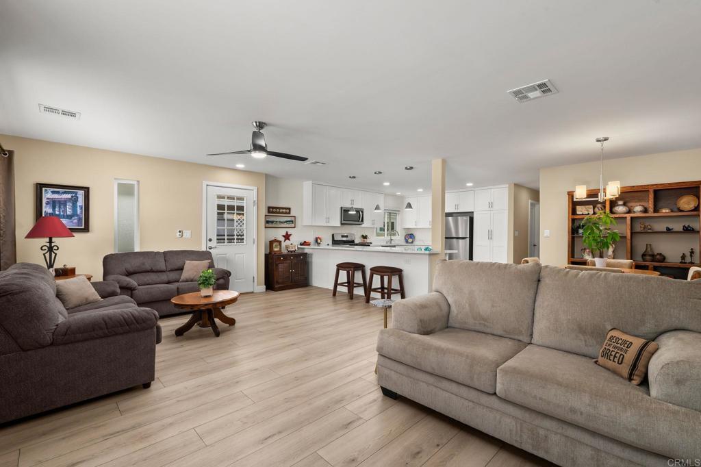 7467 Mission Gorge Road, Unit 104 Santee, CA 92071 - Photo 7 of 25 a living room with furniture and kitchen view