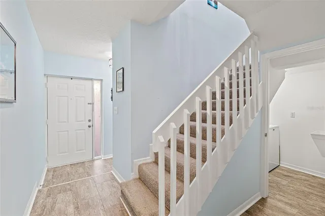 a living room with couches a dining table and couches with kitchen view