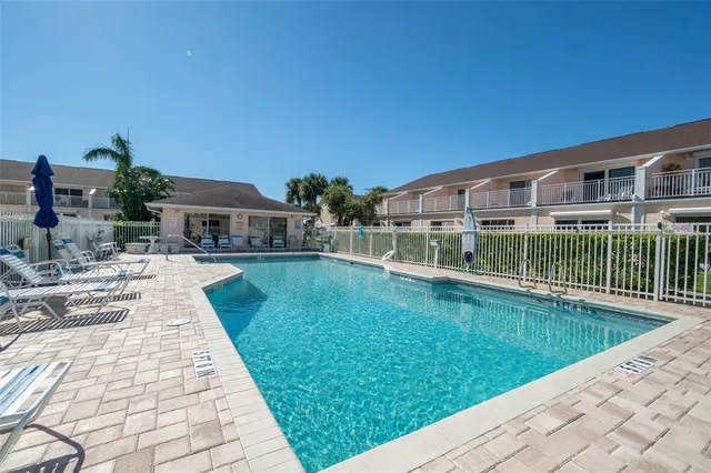 an aerial view of a house with a swimming pool outdoor seating and yard