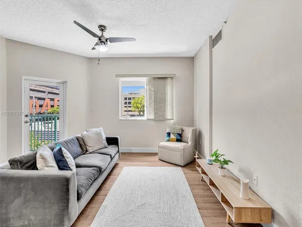 a living room with furniture and wooden floor