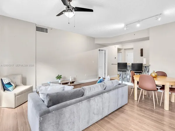 a living room with furniture and a ceiling fan