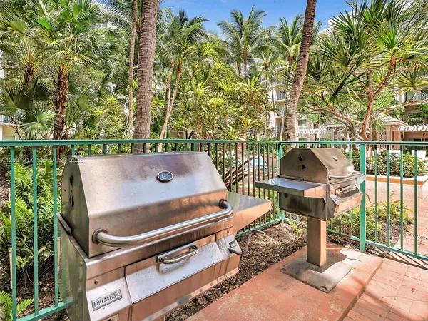 a kitchen with stainless steel appliances kitchen island granite countertop a refrigerator and a stove top oven