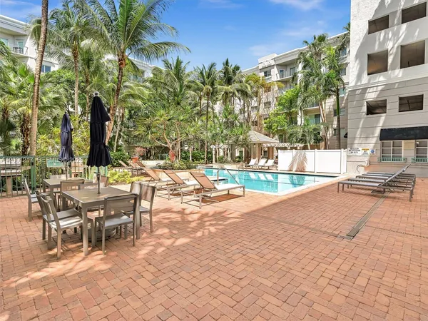 a living room with furniture a chandelier and a rug