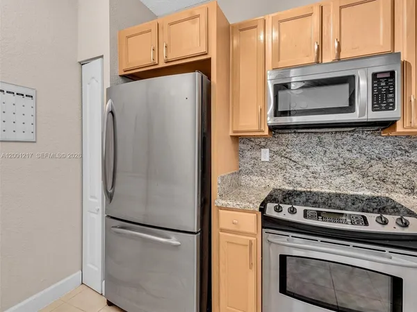 a kitchen that has a sink and a stove in it
