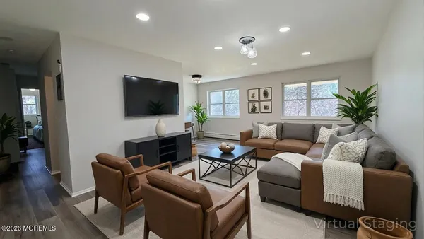 a living room with furniture a flat screen tv and a fireplace