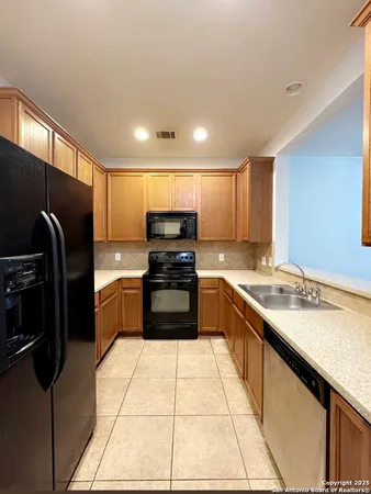 a kitchen with stainless steel appliances granite countertop a refrigerator and a stove top oven