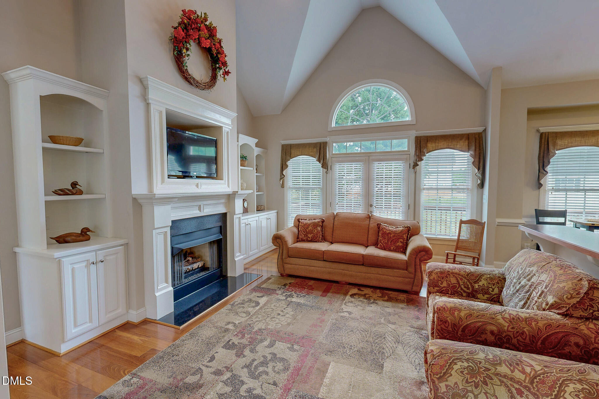 115 Duncan Plantation Road Timberlake, NC 27583 - Photo 25 of 48 a living room with furniture a fireplace and a large window