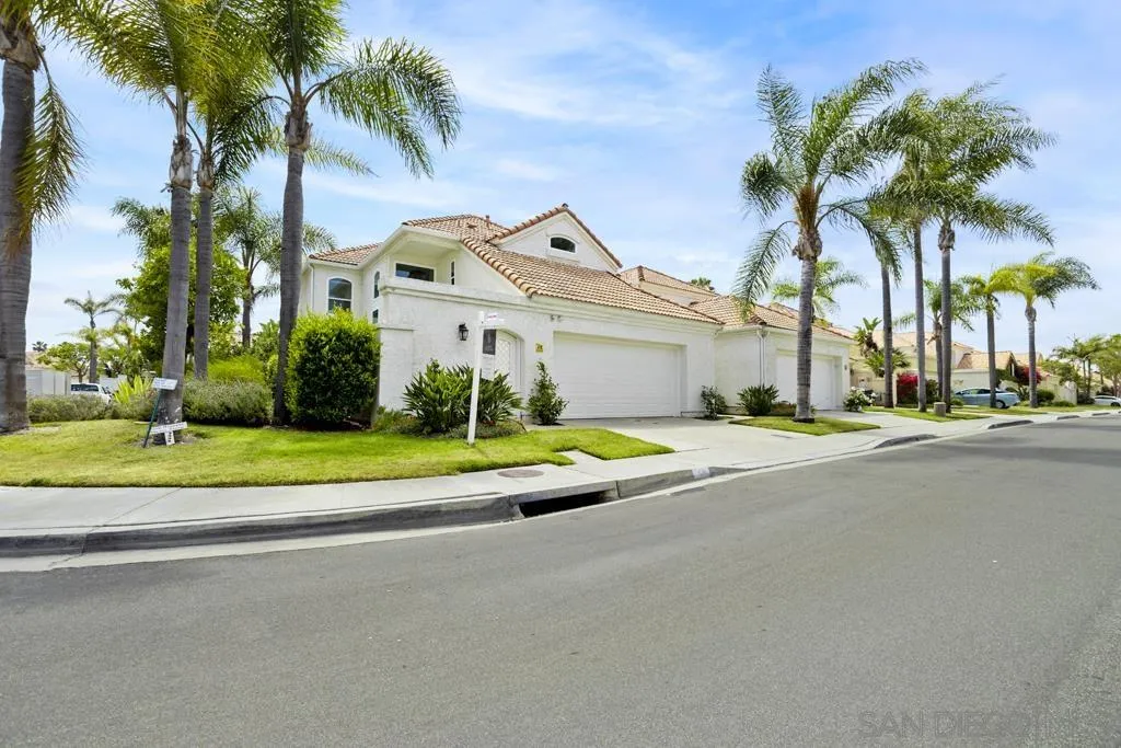48 Port Royale Road Coronado, CA 92118 - Photo 54 of 56 a view of a white house with a swimming pool and palm trees