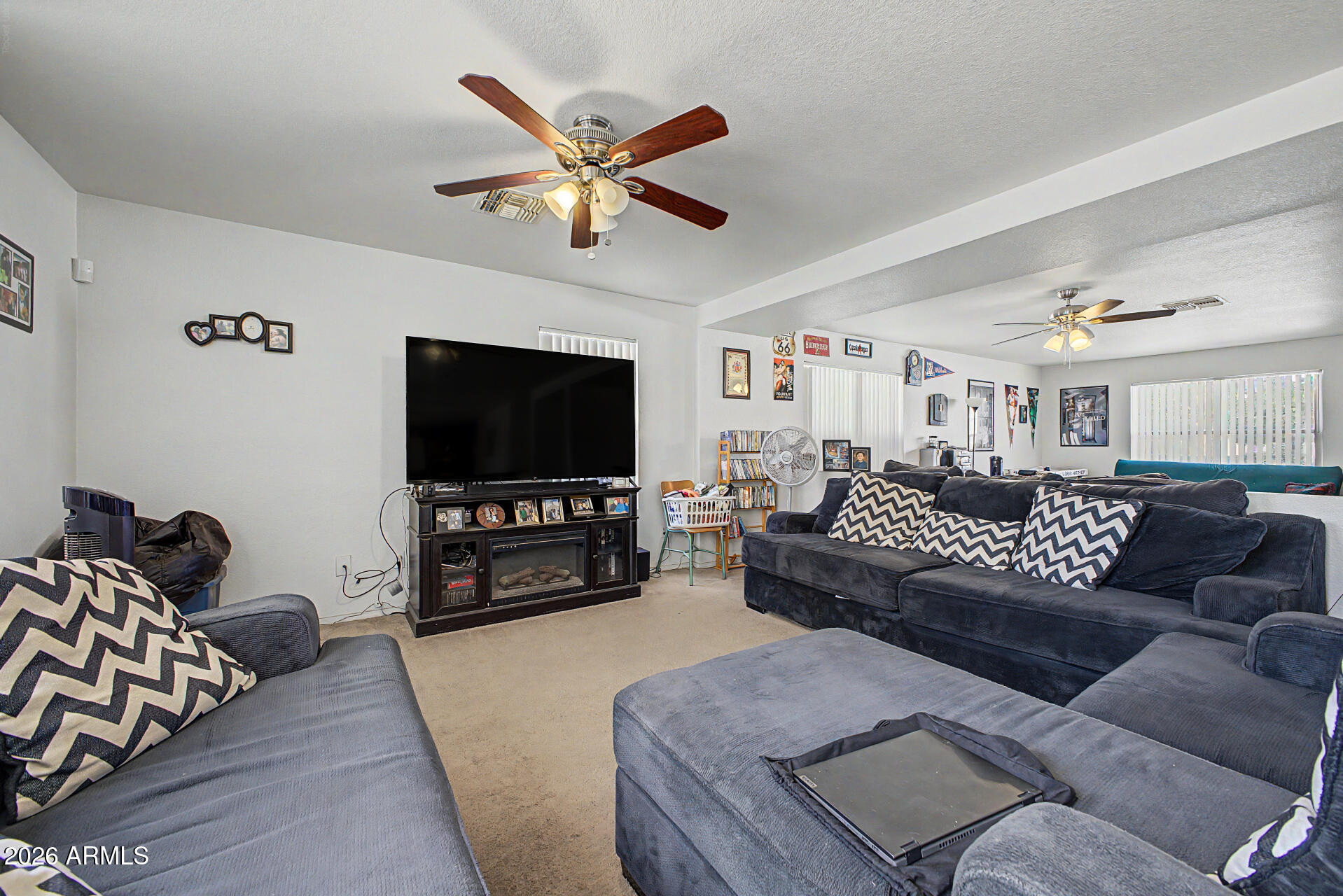 2607 West Bloch Road Phoenix, AZ 85041 - Photo 7 of 34 a living room with furniture and a flat screen tv