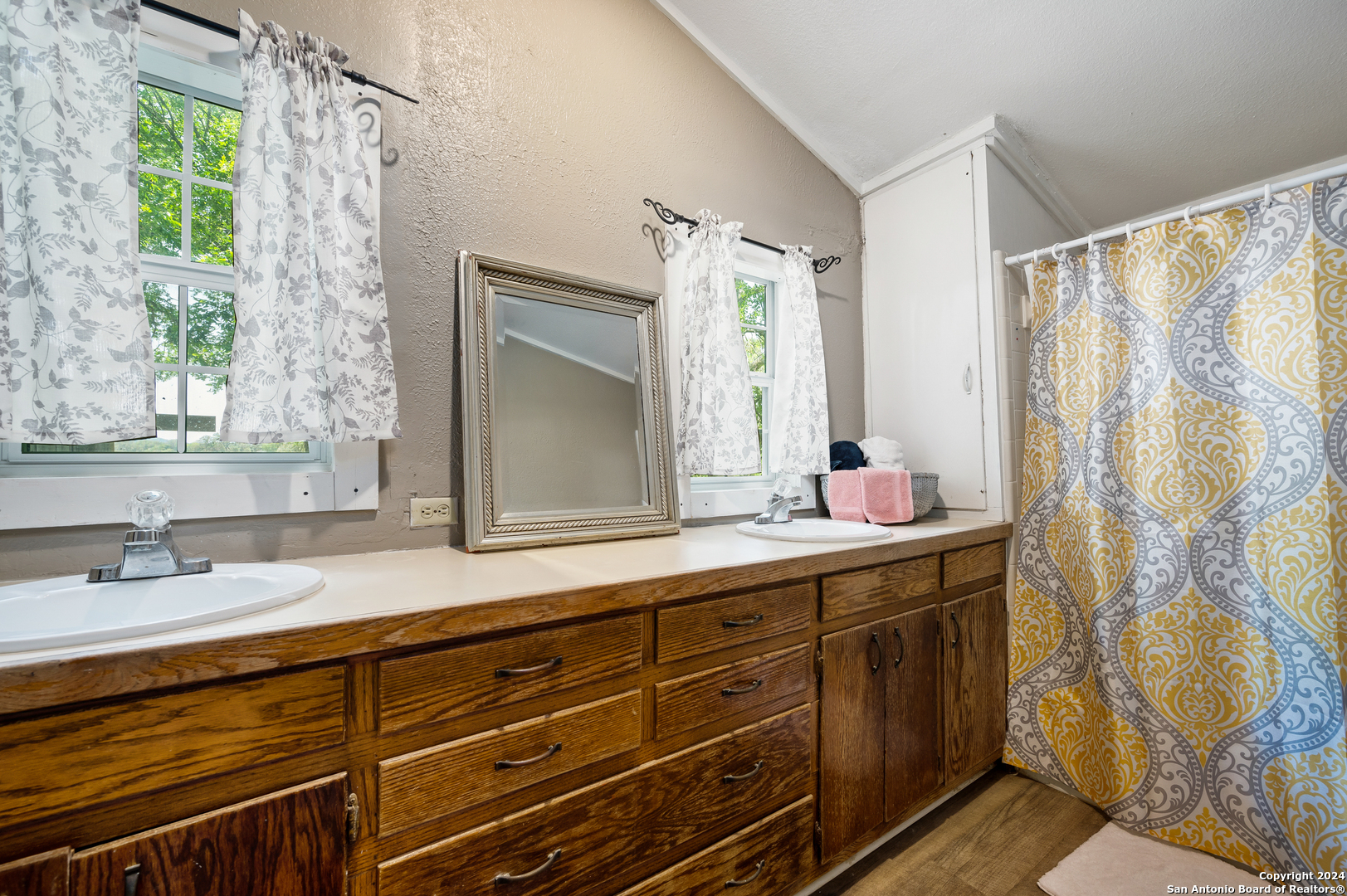 109 Waring Welfare Road Boerne, TX 78006 - Photo 15 of 21 a bathroom with a double vanity sink and a mirror