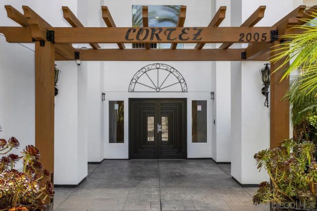 a view of entryway with a front door and wooden floor