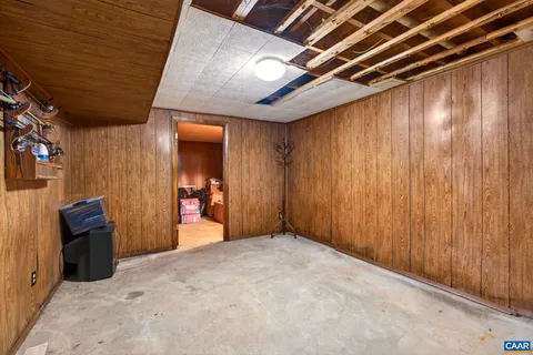 a view of a hallway with wooden walls and stairs