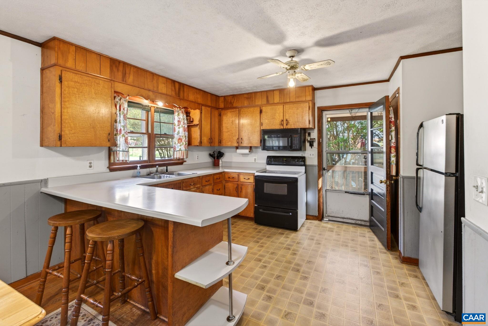 374 Locust Lane Ruckersville, VA 22968 - Photo 3 of 28 a kitchen with stainless steel appliances granite countertop a sink refrigerator stove and microwave