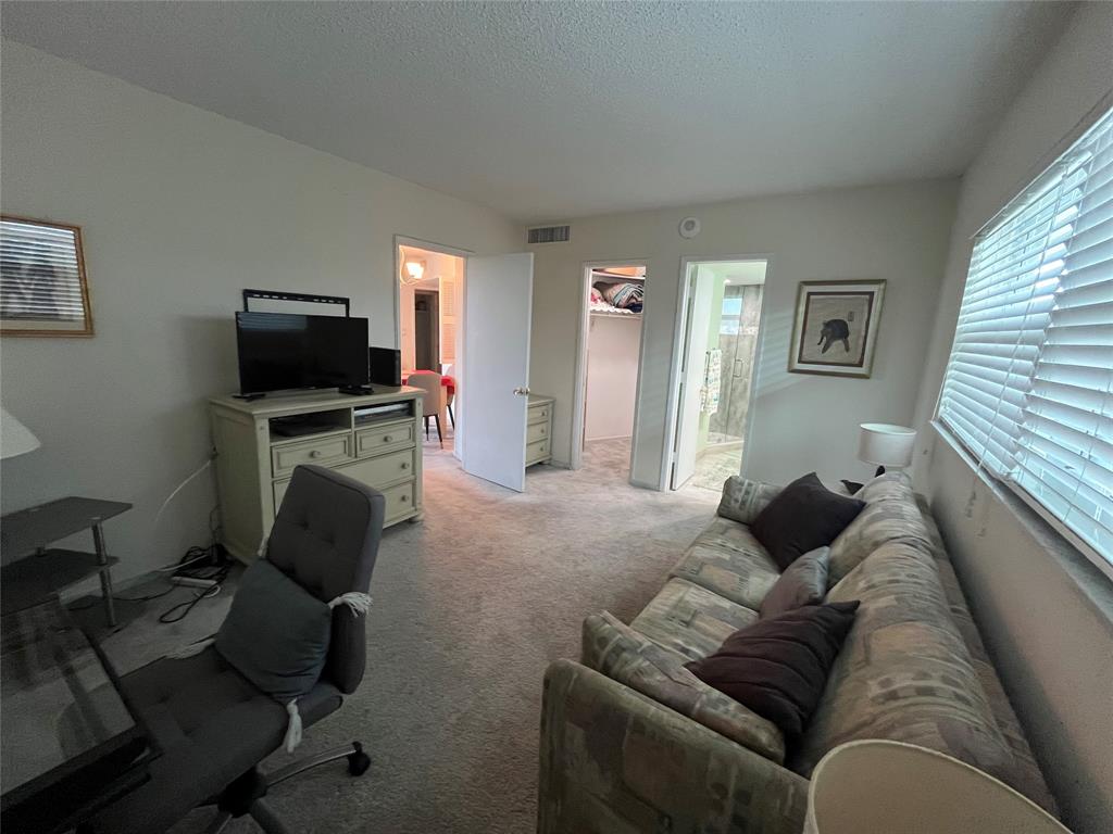 333 Northeast 21st Avenue, Unit 318 Deerfield Beach, FL 33441 - Photo 18 of 40 a living room with furniture and a flat screen tv