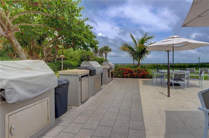 333 Northeast 21st Avenue, Unit 318 Deerfield Beach, FL 33441 - Photo 26 of 40 a view of a backyard and swimming pool