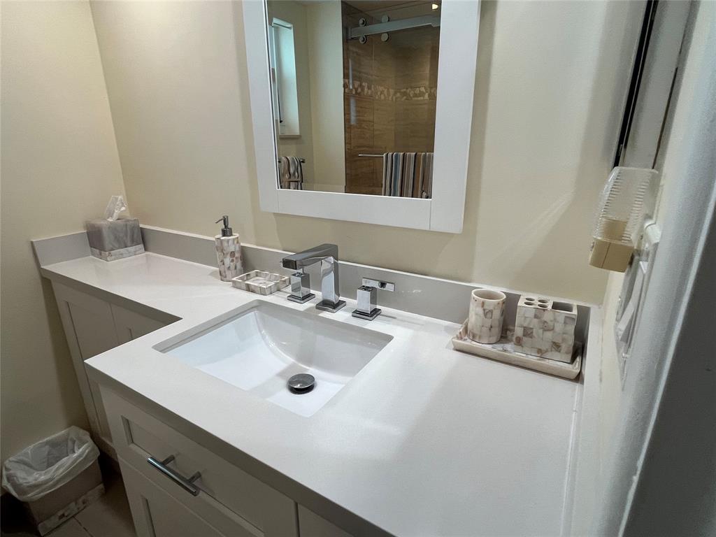 333 Northeast 21st Avenue, Unit 318 Deerfield Beach, FL 33441 - Photo 10 of 40 a bathroom with a sink and a mirror