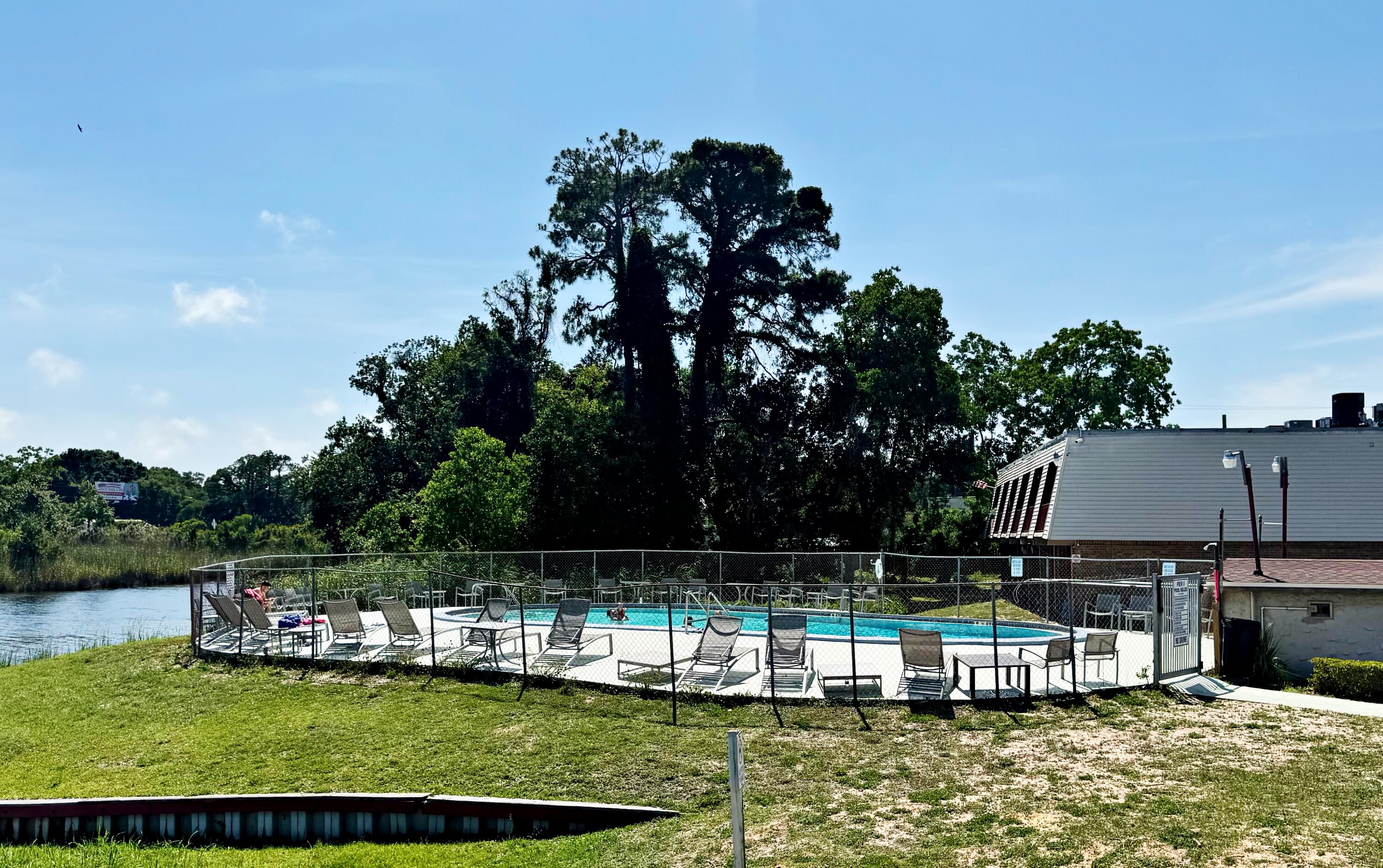 210 Pelham Road, Unit 215B Fort Walton Beach, FL 32547 - Photo 16 of 23 a view of small house with a large pool