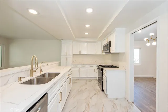 a kitchen with a sink stove top oven and cabinets