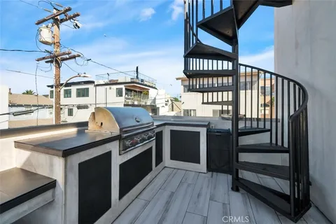 a kitchen with a stove and a chandelier