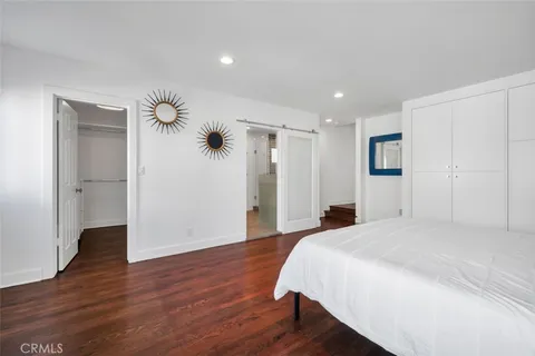 a spacious bedroom with a bed and a chandelier