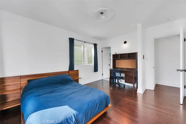 a bedroom with furniture and a flat screen tv