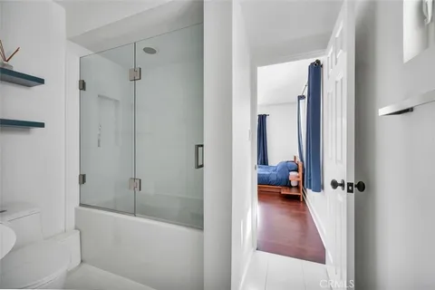 a en suite bathroom with a tub shower and a sink