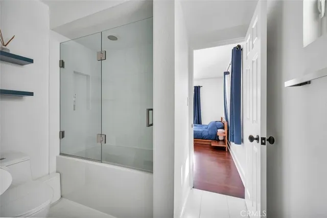 a en suite bathroom with a tub shower and a sink