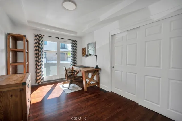 a view of a workspace with furniture and wooden floor