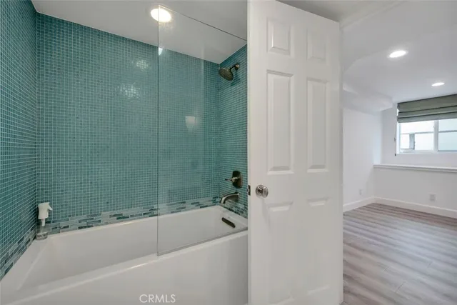 a bathroom with a bathtub and a shower
