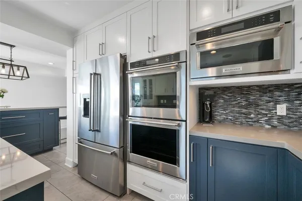 a kitchen with granite countertop white cabinets stainless steel appliances and counter space