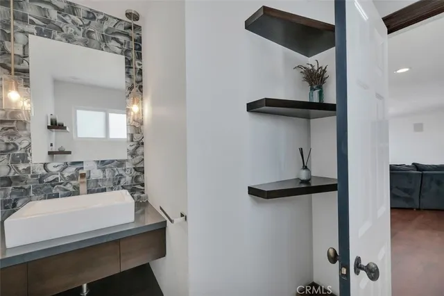 a bathroom with a sink a mirror and shower