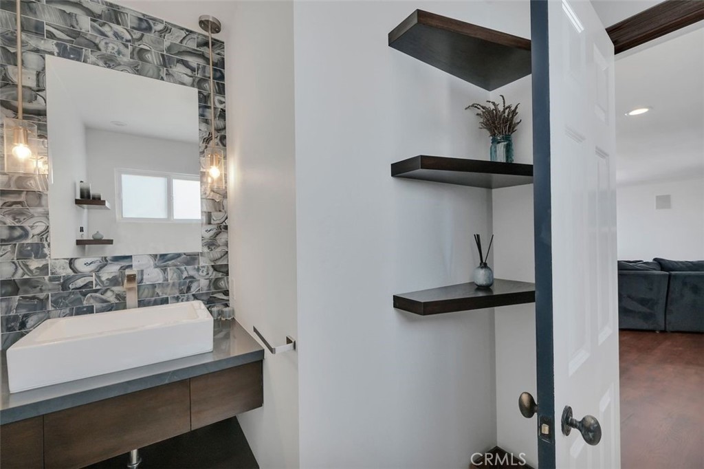 225 33rd Street Hermosa Beach, CA 90254 - Photo 10 of 37 a bathroom with a sink a mirror and shower