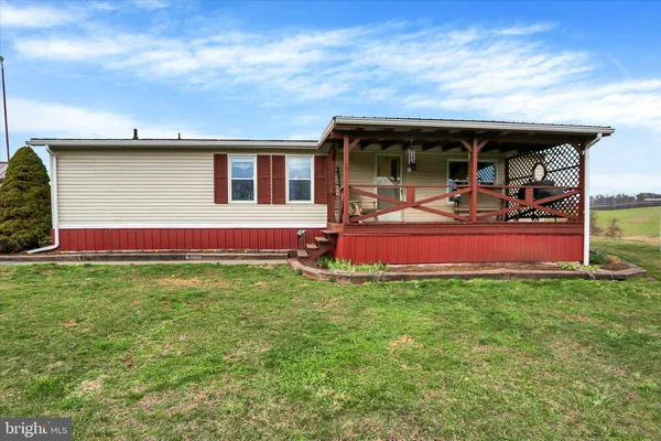 a view of a house with backyard porch and sitting area