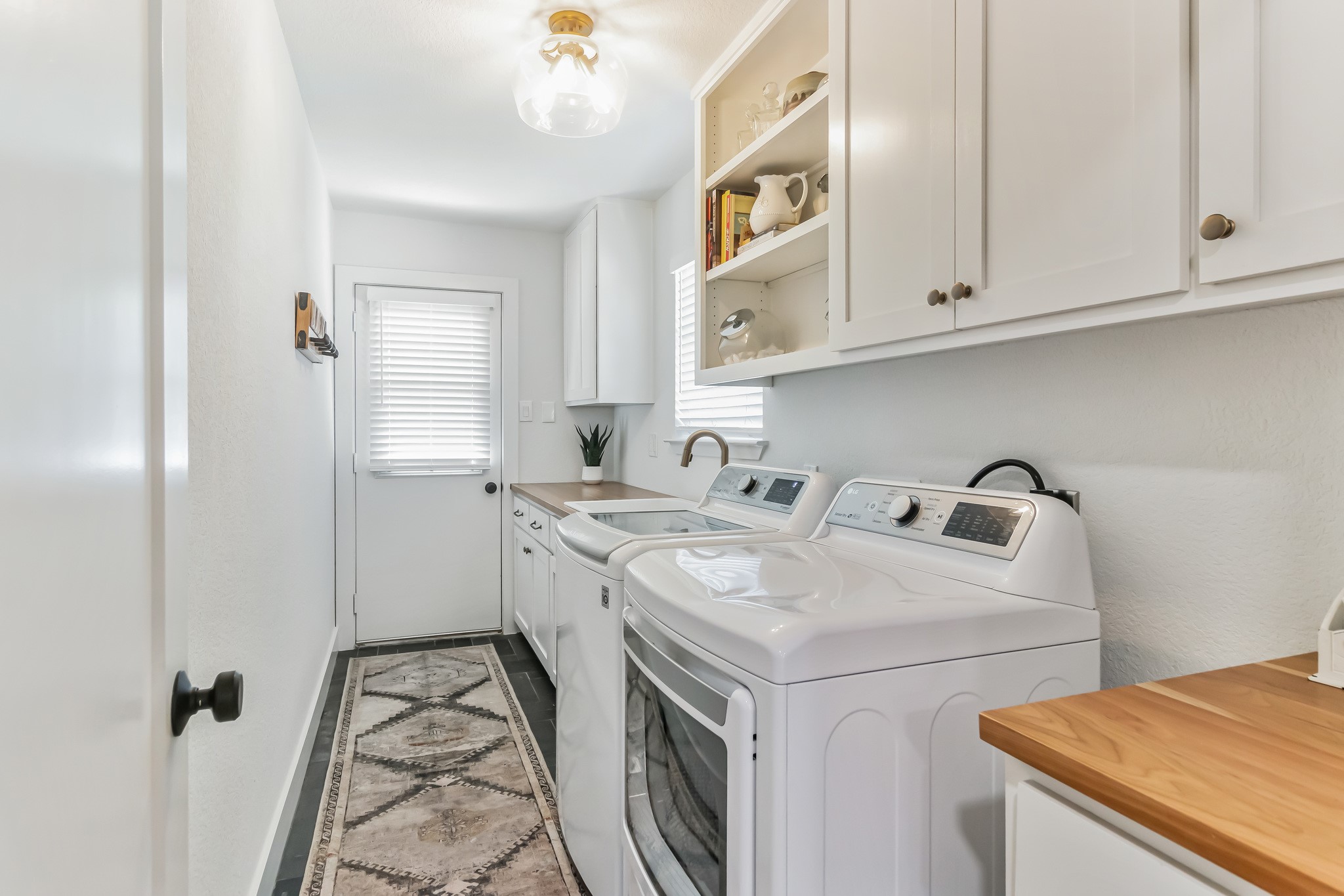 213 Clear Springs Road Georgetown, TX 78628 - Photo 18 of 33 Good Sized Laundry Room off Flex Room with Open and Closed Cabinets, Sink and Plenty of Counter space. Also Backyard Access