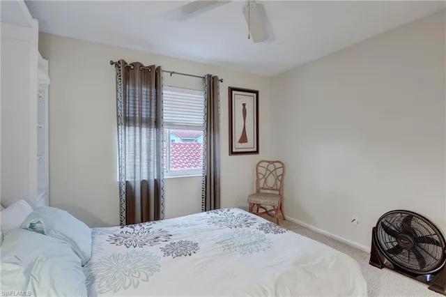 a bedroom with a bed a dresser and a window