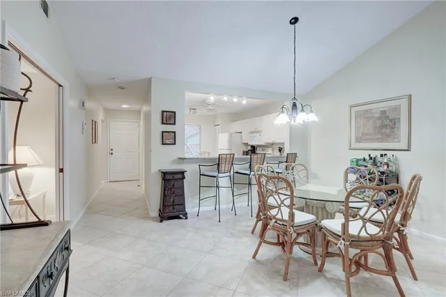 a view of a dining room with furniture and a chandelier