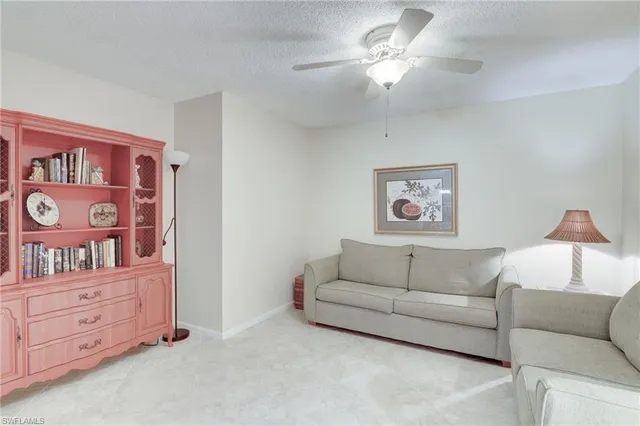 a living room with furniture and a lamp