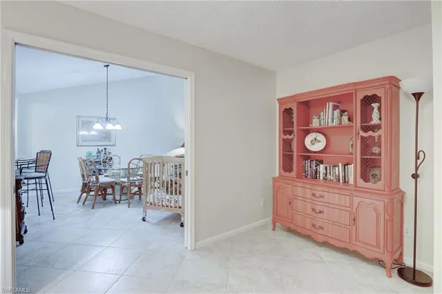a view of a room that has a table and chairs in it