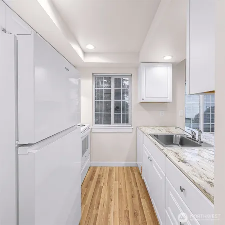 a kitchen with a sink stove and cabinets