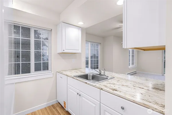 a kitchen with a sink cabinets and chandelier