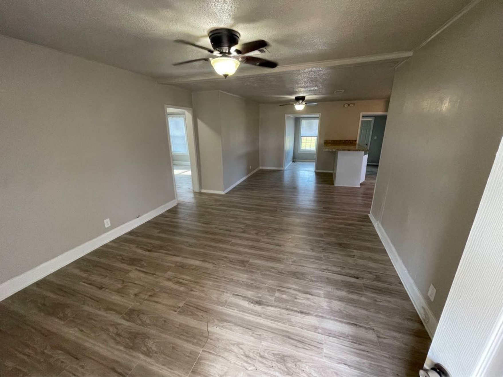 1649 19th Street Port Arthur, TX 77640 - Photo 2 of 8 a view of a hallway with wooden floor