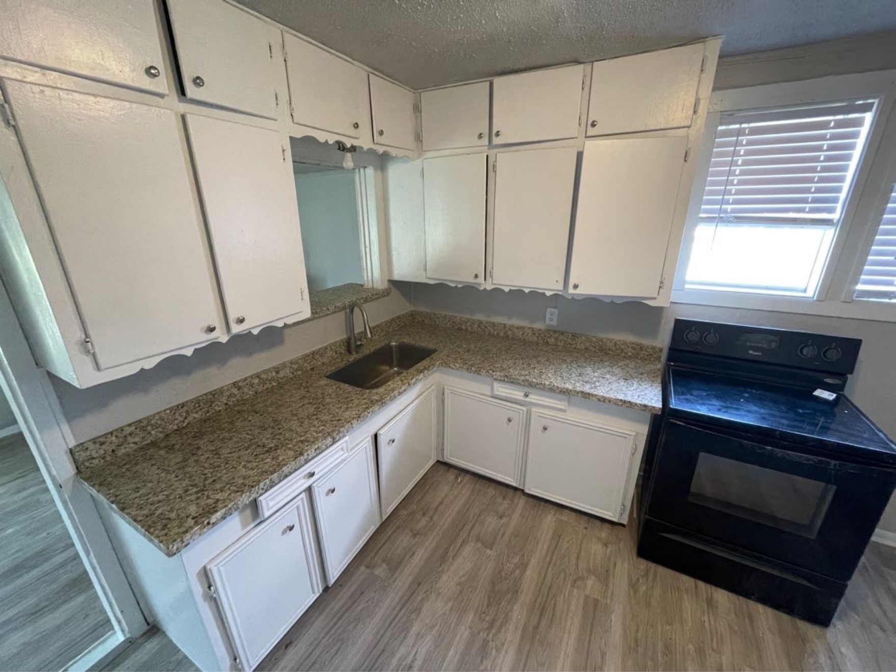 1649 19th Street Port Arthur, TX 77640 - Photo 4 of 8 a kitchen with sink stove and cabinets