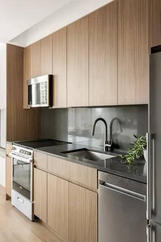 a kitchen with granite countertop white cabinets and white appliances