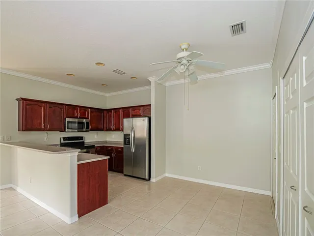 a kitchen with stainless steel appliances a refrigerator and a stove top oven