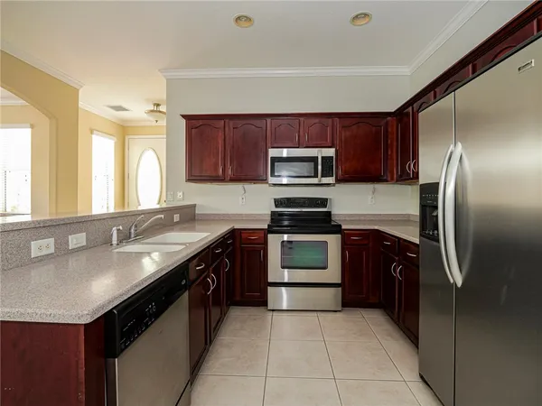 a kitchen with a sink stove and refrigerator