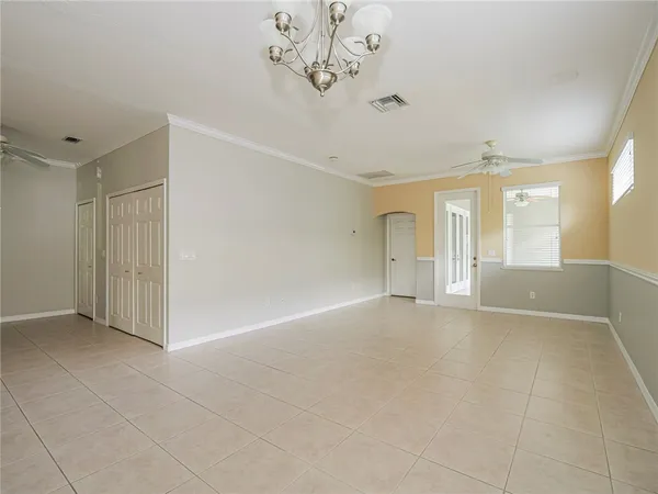 an empty room with windows and entrance